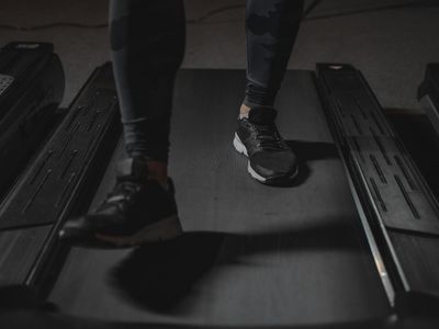 Blurred motion of a person running on a treadmill.