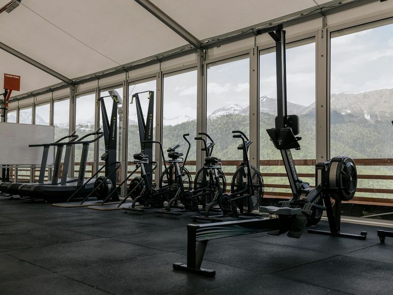 Wide shot of a clean modern gym with cardio equipment.